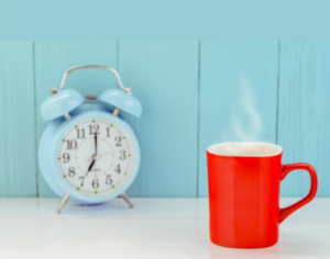 Coffee mug and clock representing morning coffee routine