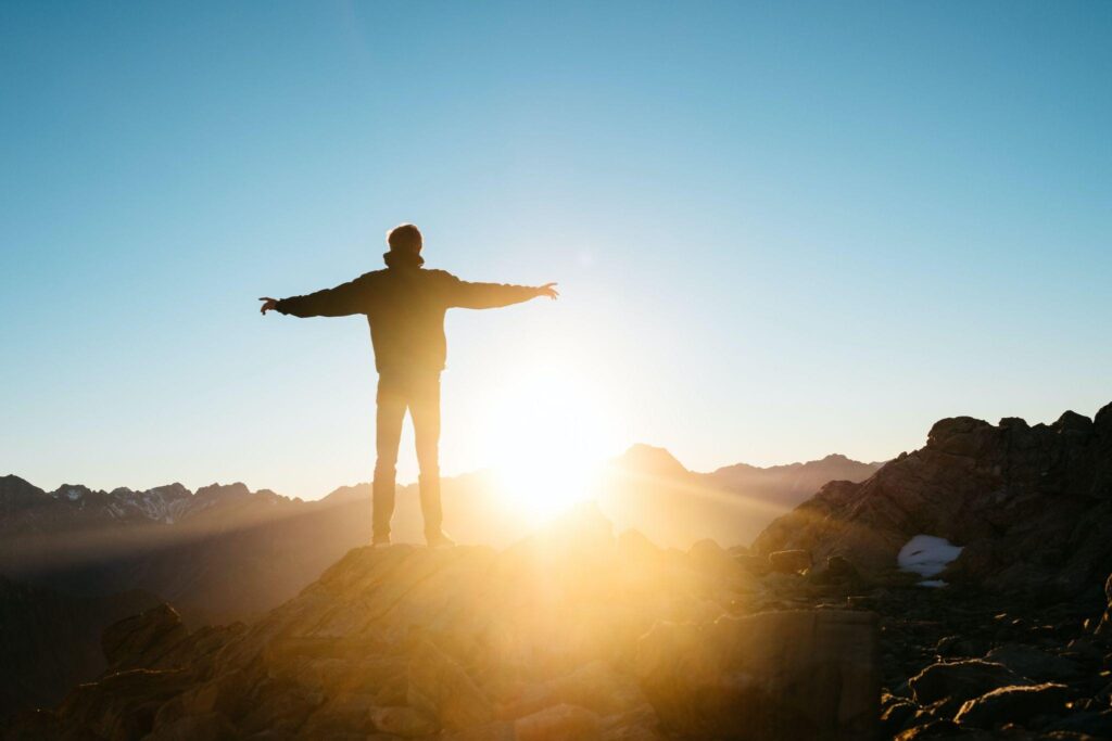 man facing sunset on mountain