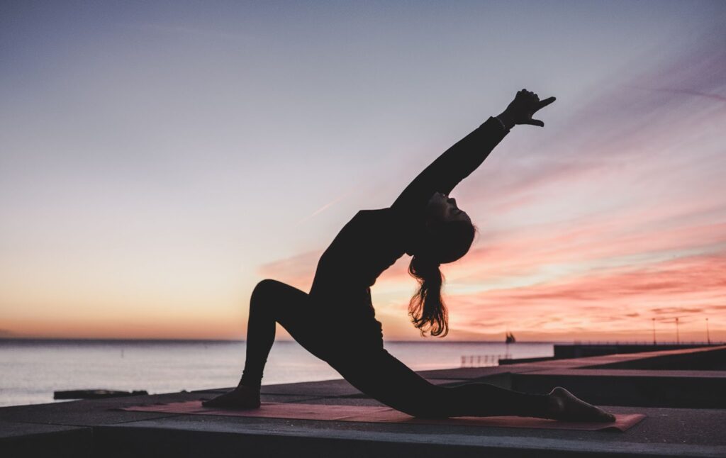 woman on the beach doing yoga