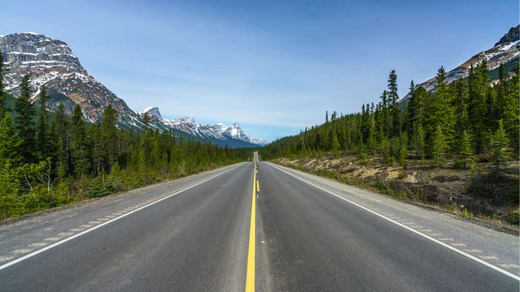 open road surrounded by mountains