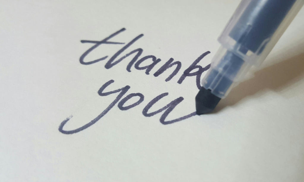 pen writing thank you in blue ink