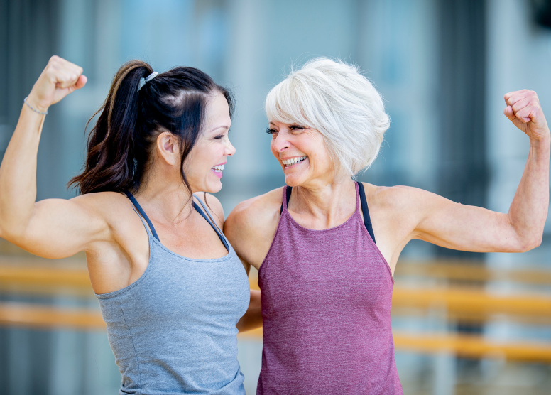 two women in exercise clothes showing off their muscles