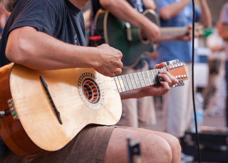 two men playing guitars