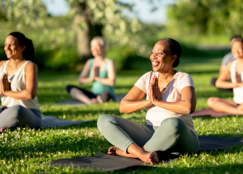 group of women doing yoga outdoors