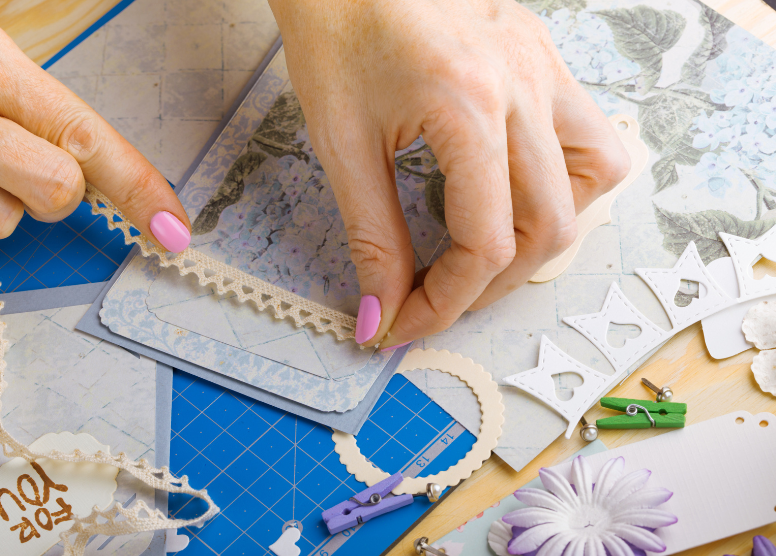 close up shot of a woman's hands doing scrapbooking