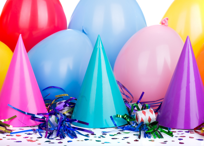 brightly colored balloons, party hats, noisemakers, and confetti