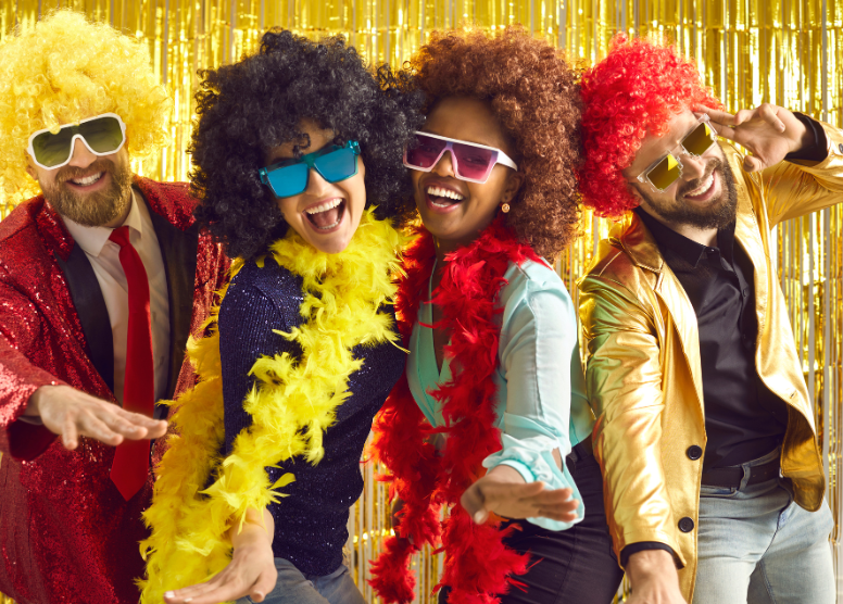 fun photo booth with a group of 4 people dressed in 1970s style costumes