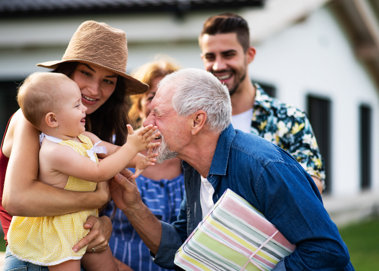 family group -- grandparents, couple, baby