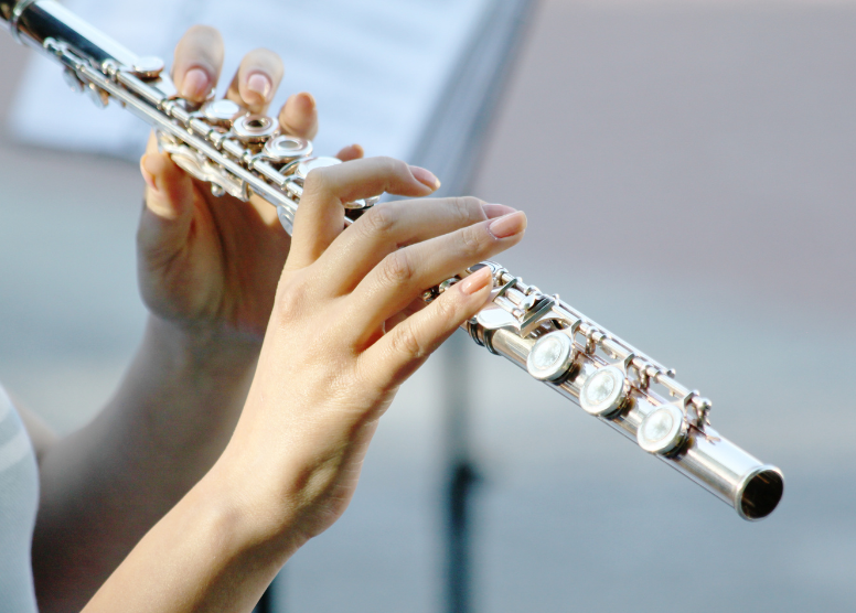 close up of person playing the flute