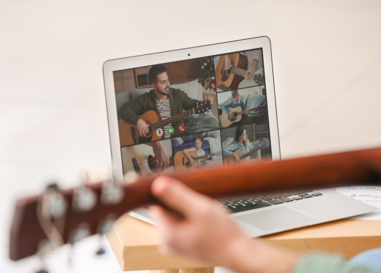 close up of a person taking an online guitar lesson