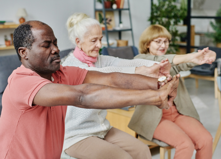 3 older people stretching together