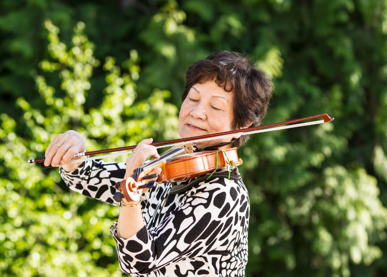 woman playing the violin outside