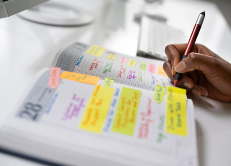 close up of person writing in a planner