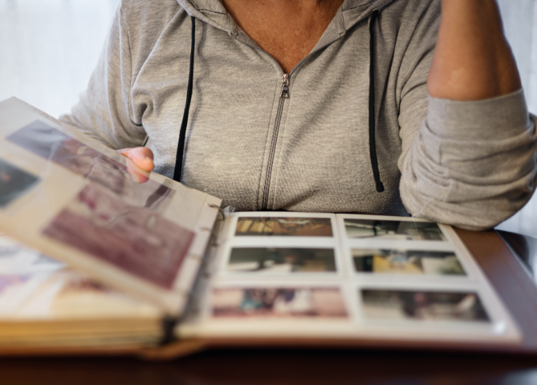 close up of woman looking at photos in an album