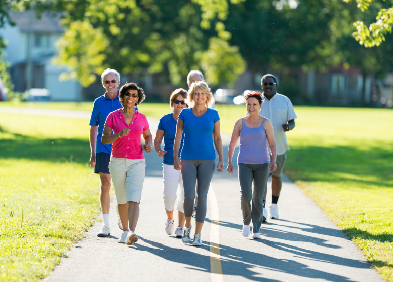 group of seniors walking on a paved path