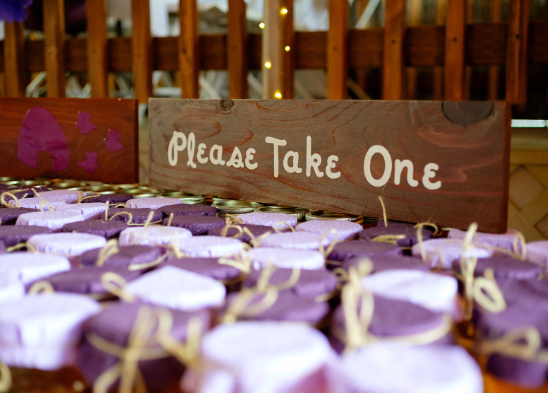 party favors on a table with a sign that says "please take one"